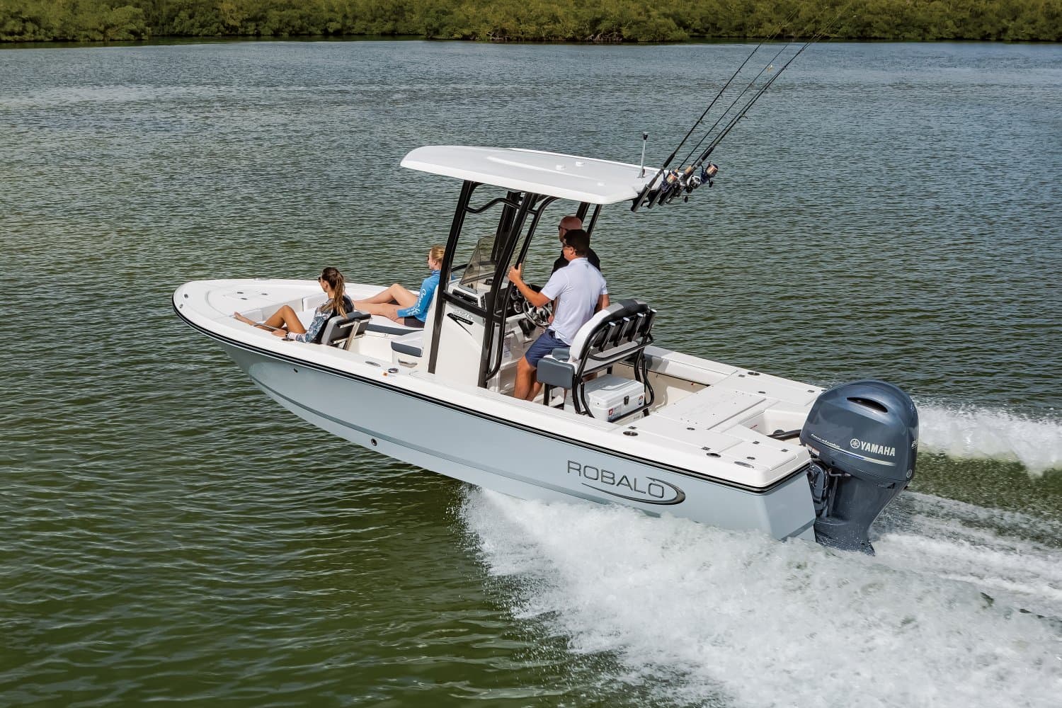 Robalo 226 Cayman running past a mangrove shoreline with four people aboard, seen from above off the port quarter.