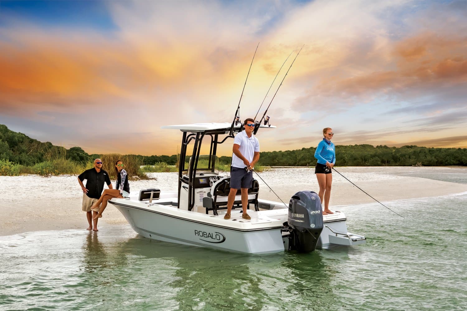 Robalo 226 Cayman beached on a sandbar at sunset, two anglers casting from the deck while two others stand in the shallows alongside the bow.